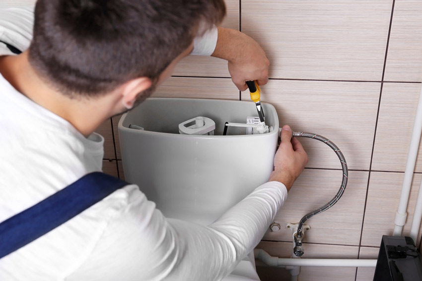 Plumber Installing A Toilet — Plumber To Your Door in Jensen, QLD